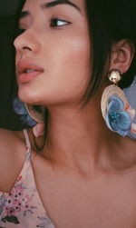 Close-up portrait of a young woman looking away