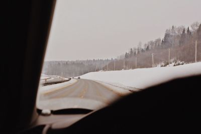 Panoramic view of road seen through car windshield