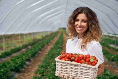 Portrait of smiling young woman in basket