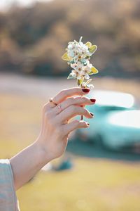 Midsection of woman holding flower bouquet