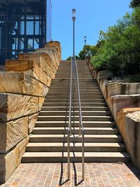 Staircase amidst footpath against sky