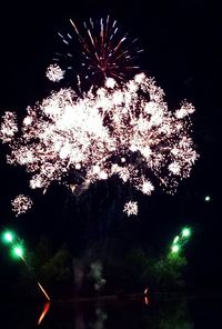 Low angle view of firework display at night