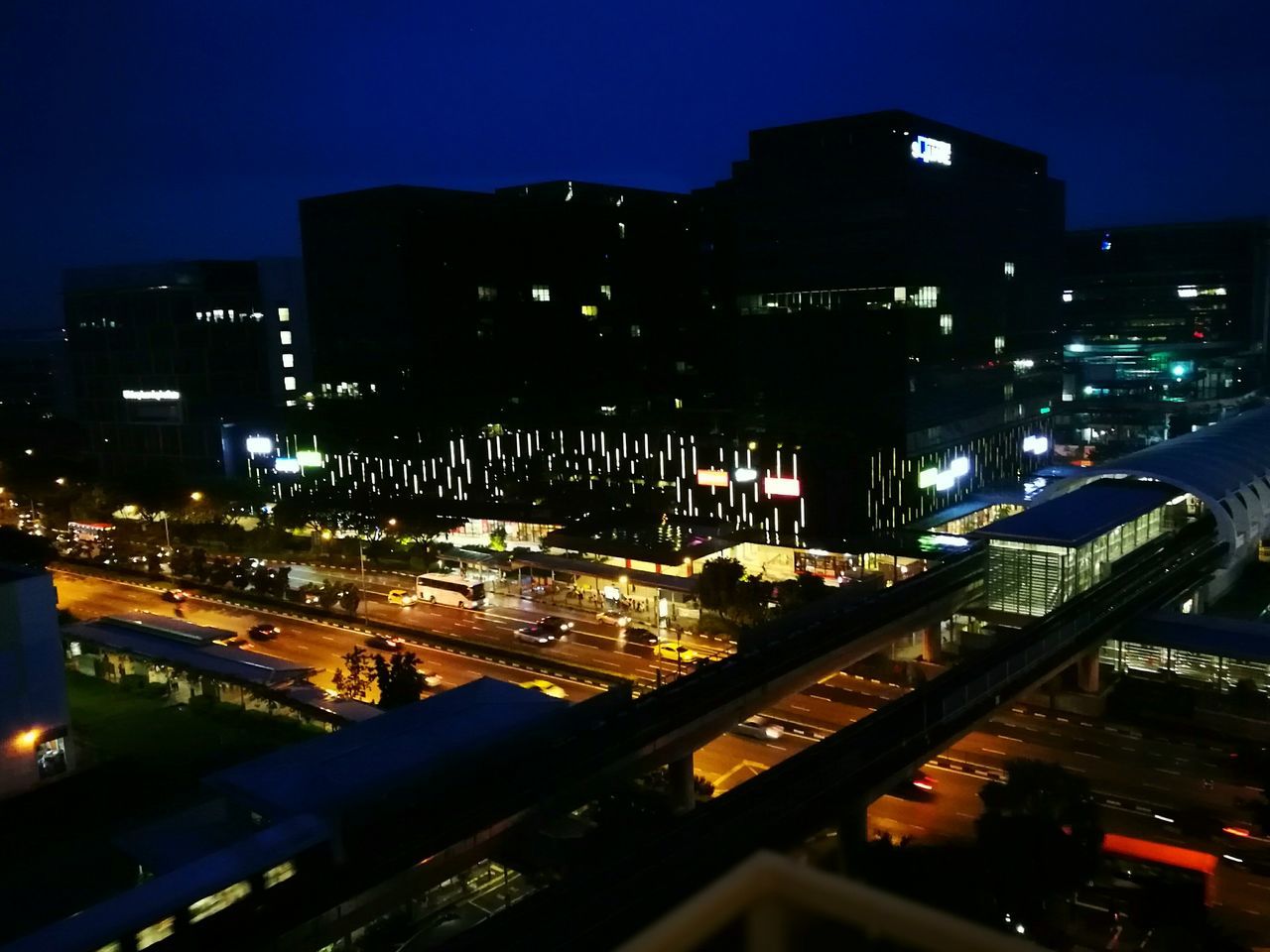 night, illuminated, city, building exterior, architecture, transportation, built structure, sky, cityscape, outdoors, traffic, city life, skyscraper, no people, land vehicle, road, bridge - man made structure, urban skyline