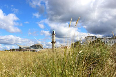 Traditional windmill on field against sky