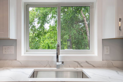 Remodeled kitchen  interior has new sink installed 