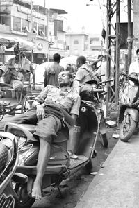 People riding motorcycle on street in city