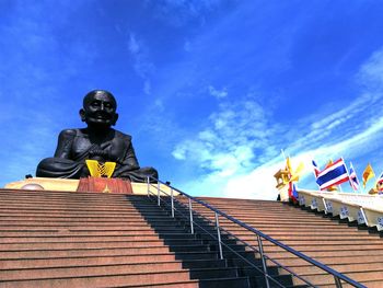 Low angle view of statue against blue sky