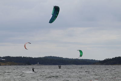 Kite flying over sea against sky