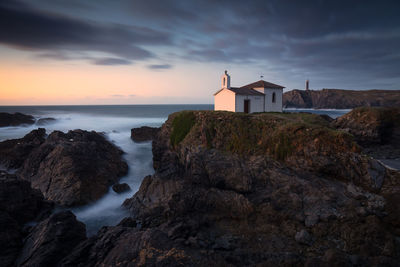 Oneiric seascape with a hermitage on the coast