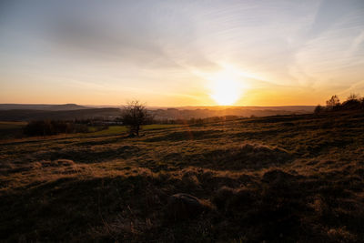 Scenic view of land against sky during sunset