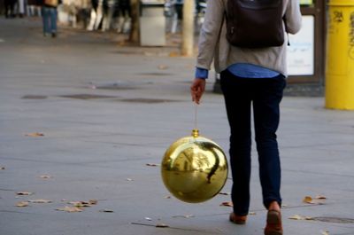 Midsection of woman holding umbrella