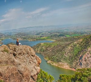 Man looking at view of mountain against sky