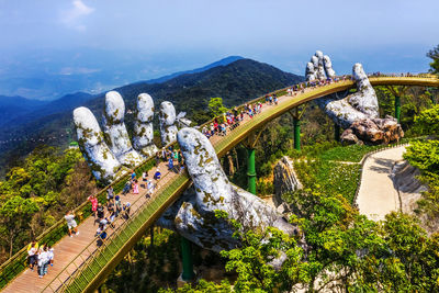 High angle view of people on mountain against sky