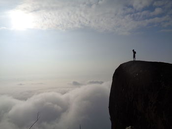 Low angle view of man standing on mountain