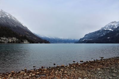 Scenic view of lake and mountains against sky