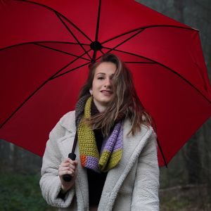 Portrait of young woman with umbrella