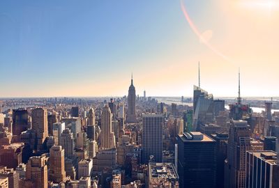 Cityscape against sky on sunny day