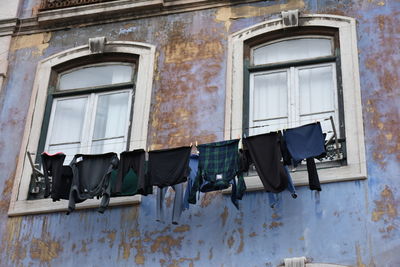 Low angle view of clothes drying on old building