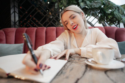 Midsection of woman sitting on table