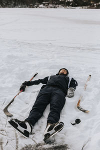 Smiling man lying on snow
