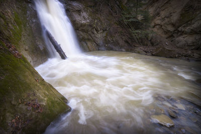 Scenic view of waterfall against sky