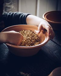 Midsection of woman holding bowl