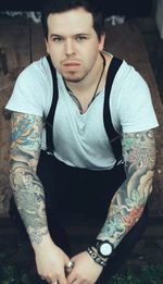 Portrait of young man sitting outdoors