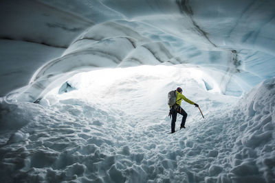 Climber, paul mcsorley, explores an ice cave on a mountaineering trip.
