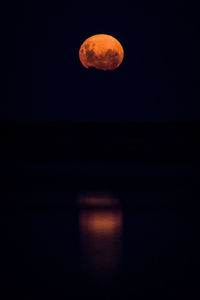 Low angle view of moon against sky at night