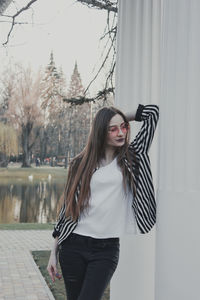 Beautiful woman standing against wall