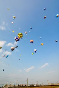 Low angle view of hot air balloons flying in sky