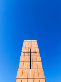 Low angle view of tower against blue sky