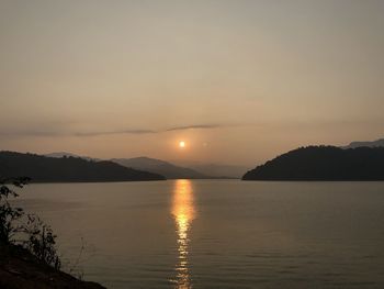 Scenic view of lake against sky during sunset