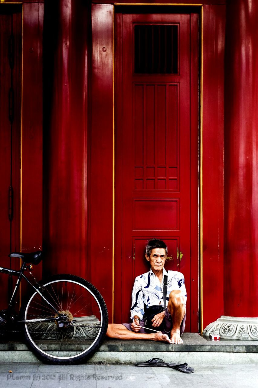 red, door, building exterior, full length, transportation, bicycle, architecture, built structure, land vehicle, mode of transport, street, side view, casual clothing, front view, lifestyles, outdoors, childhood, sidewalk