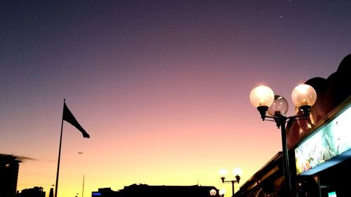 Low angle view of illuminated street light against sky