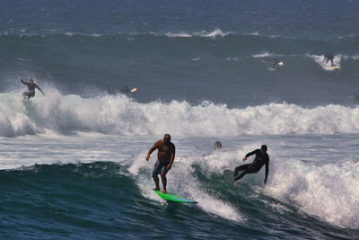 People surfing in sea