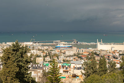 High angle view of buildings and sea against sky