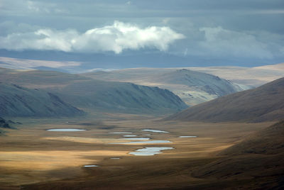 Aerial view of landscape against cloudy sky