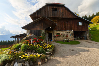 Built structure by house against sky