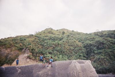 People on mountain road against sky