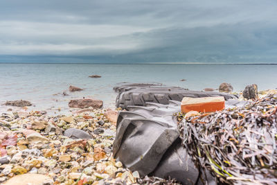 Garbage on beach against sky