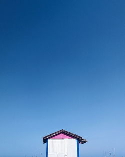 Low angle view of building against clear blue sky