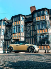 Car on street against buildings in city