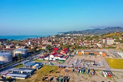 High angle view of city by sea against clear sky