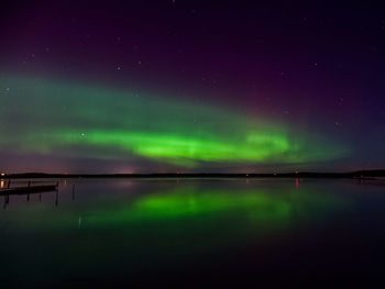 Reflection of aurora borealis on river at night
