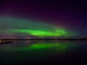 Scenic view of lake against sky at night