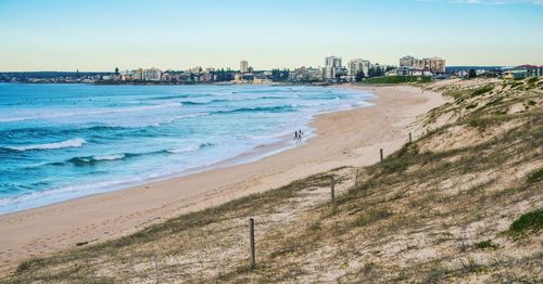 View of beach with city in background