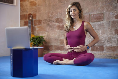 Girl doing yoga classes online
