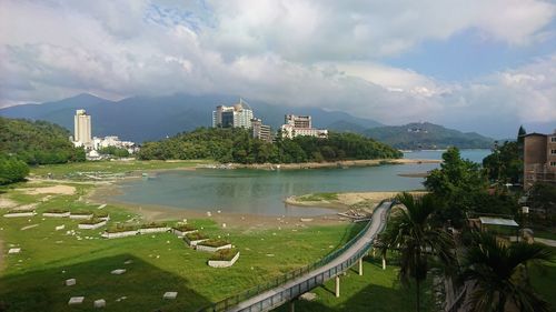 Panoramic view of buildings and river against sky