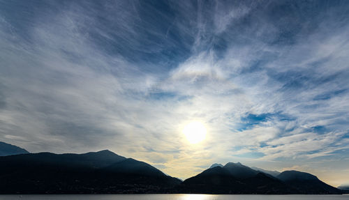 Scenic view of silhouette mountains against sky at sunset